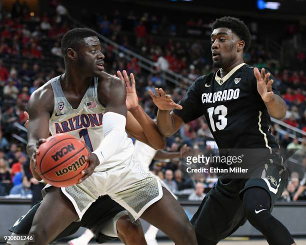 Rawle Alkins of the Arizona Wildcats is guarded by Namon Wright of the Colorado Buffaloes during a quarterfinal game of the Pac-12 basketball...