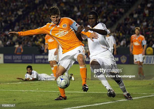 Bobby Boswell of the Houston Dynamo and Edson Buddle of the Los Angeles Galaxy of the Los Angeles Galaxy vie for the ball in the first half of extra...