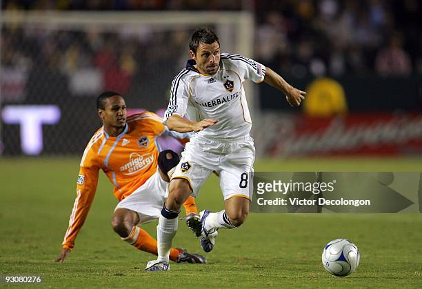 Dema Kovalenko of the Los Angeles Galaxy plays the ball past Ricardo Clark of the Houston Dynamo during the MLS Western Conference Championship match...