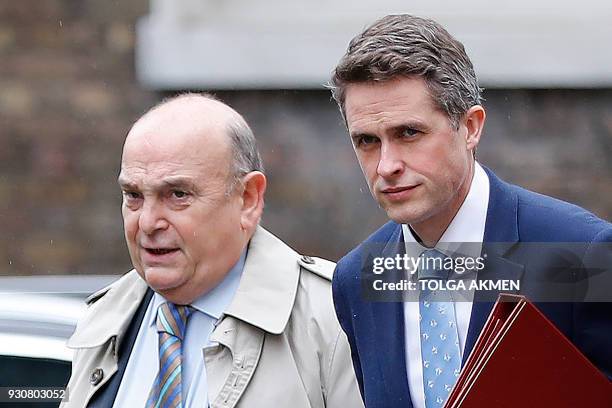 Britain's Air Chief Marshall Stuart Peach and Britain's Defence Secretary Gavin Williamson arrive in Downing Street in central London on March 12...