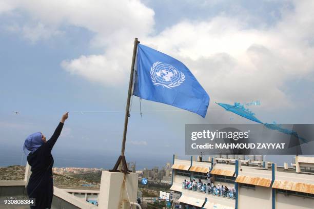 Palestinian refugee flies a kite at a school belonging to the United Nations Relief and Works Agency for Palestinian Refugees in the town of Sebline...