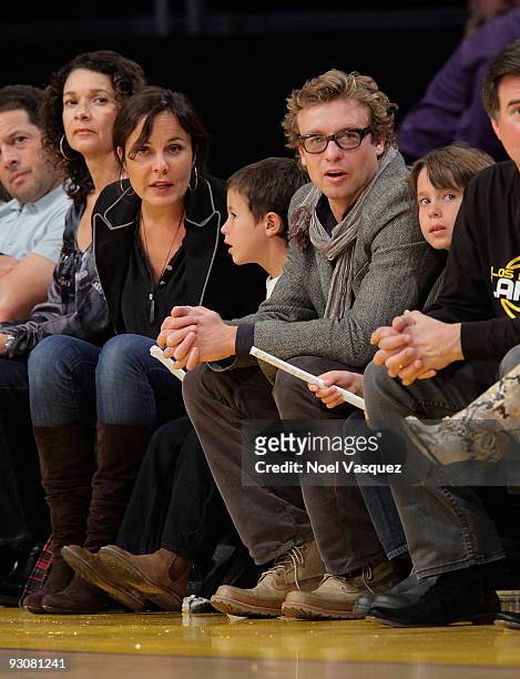 Rebecca Rigg, Harry Friday, Simon Baker and Claude Blue attend a game between the Houston Rockets and the Los Angeles Lakers at Staples Center on...
