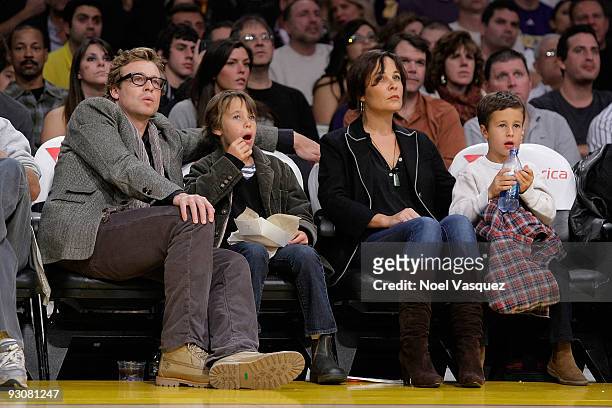 Simon Baker, Claude Blue, Rebecca Rigg and Harry Friday attend a game between the Houston Rockets and the Los Angeles Lakers at Staples Center on...