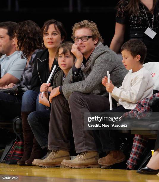 Rebecca Rigg, Claude Blue, Simon Baker and Harry Friday attend a game between the Houston Rockets and the Los Angeles Lakers at Staples Center on...
