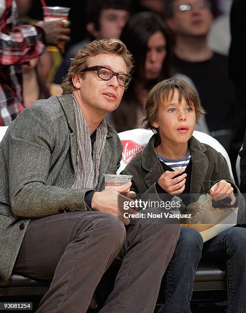 Simon Baker and Claude Blue attend a game between the Houston Rockets and the Los Angeles Lakers at Staples Center on November 15, 2009 in Los...