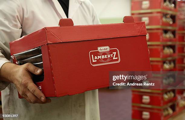 An employee holds a box of christmas cookies at the gingerbread bakery Henry Lambertz on November 13, 2009 in Aachen, Germany. Lambertz is one of the...