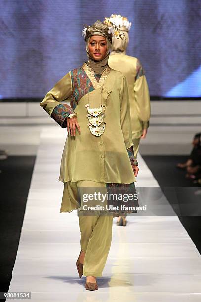 Model showcases designs on the runway by Nieta Hidayani as part of APPMI Show 1 on day three of Jakarta Fashion Week 2009 at the Fashion Tent,...