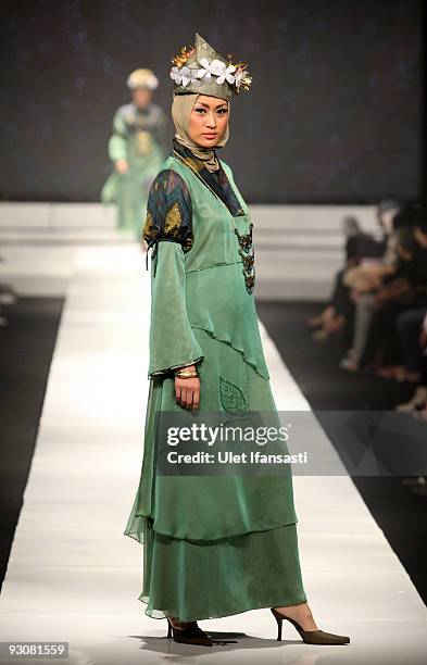 Model showcases designs on the runway by Nieta Hidayani as part of APPMI Show 1 on day three of Jakarta Fashion Week 2009 at the Fashion Tent,...