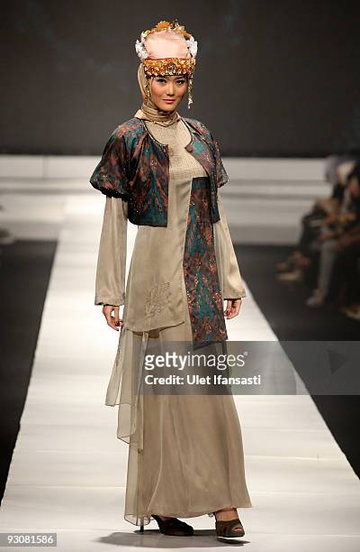 Model showcases designs on the runway by Nieta Hidayani as part of APPMI Show 1 on day three of Jakarta Fashion Week 2009 at the Fashion Tent,...