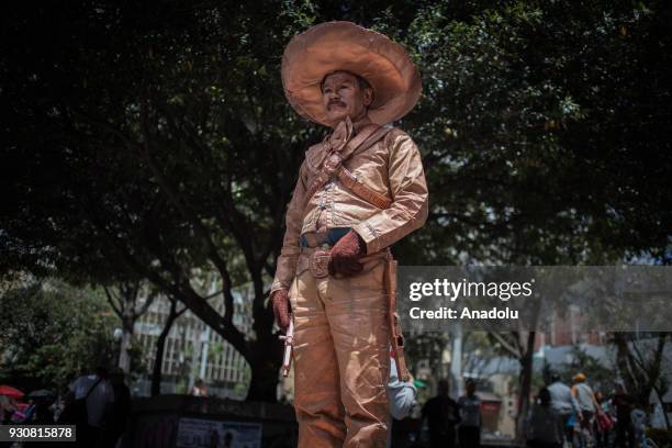 Juan de Dios who has worked as a human statue for the last 10 years, performs in Bogota, on March 11, 2018. He characterizes different characters,...