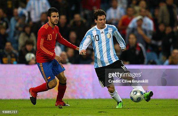 Lionel Messi of Argentina attempts to move away from Cesc Fabregas of Spain during the friendly International football match Spain against Argentina...