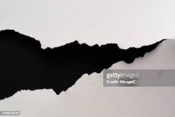 torn paper fissure - black paper stock pictures, royalty-free photos & images