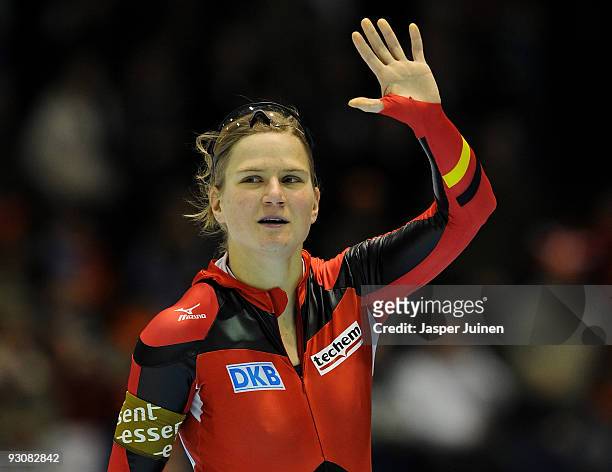Jenny Wolf of Germany waves to the fans after competing in the 500m race during the Essent ISU speed skating World Cup at the Thialf Stadium on...