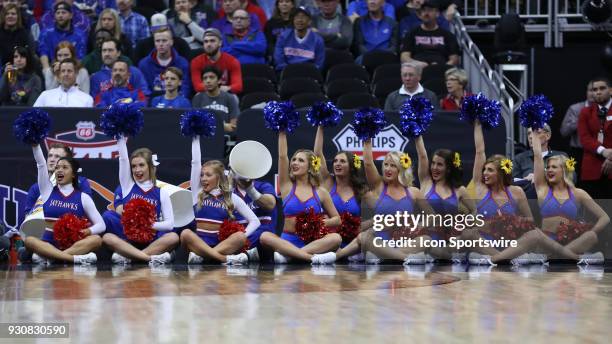 Kansas cheerleaders from the sidelines in the first half of a quarterfinal game in the Big 12 Basketball Championship between the Oklahoma State...