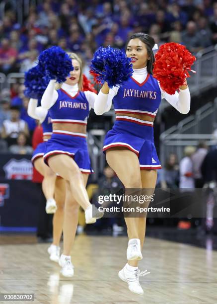 Kansas cheerleaders perform in the first half of a quarterfinal game in the Big 12 Basketball Championship between the Oklahoma State Cowboys and...