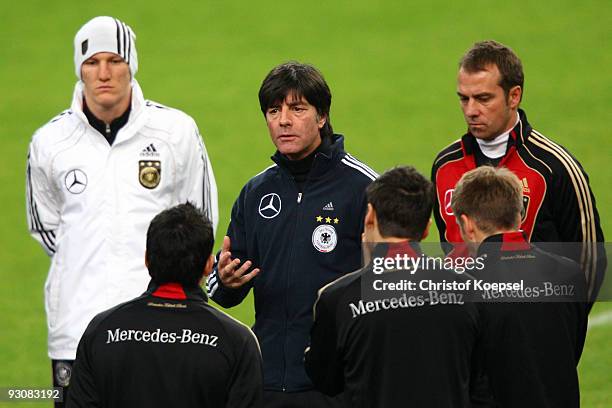 National coach Joachim Loew speaks to Bastian Schweinsteiger , Piotr Trochowski, Marcel Schaefer, Philipp Lahm and assistant coach Hansi Flick during...