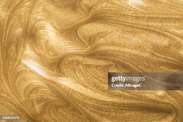 glittering gold paint - gold colored imagens e fotografias de stock