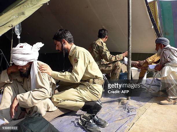 Pakistani army paramedics treat internally displaced civilians, fleeing from military operations against Taliban militants in South Waziristan, at a...