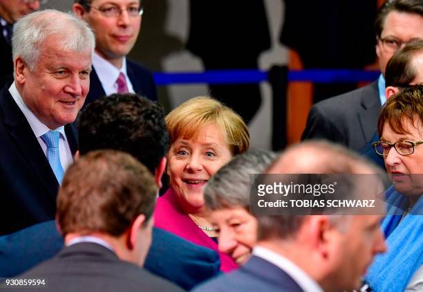German Chancellor Angela Merkel and Designated German Interior Minister Horst Seehofer greet government members, among them outgoing German Economy...
