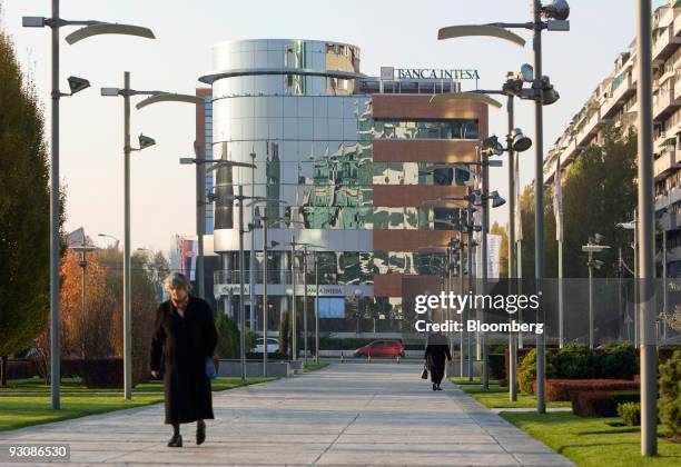 Pedestrians walk past the offices of Banca Intesa in Belgrade, Serbia, on Saturday, Nov. 14, 2009. Serbia's gross domestic product probably rose 4.1...