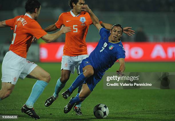 Mauro German Camoranesi of Italy is challenged by Giovanni van Bronckhorst of Holland during the international friendly match between Italy and...