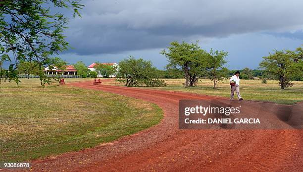 An employee walks along a road at the estate "Rincon del Socorro", of US billionaire Douglas Tompkins, in Ibera, near Carlos Pellegrini in Corrientes...