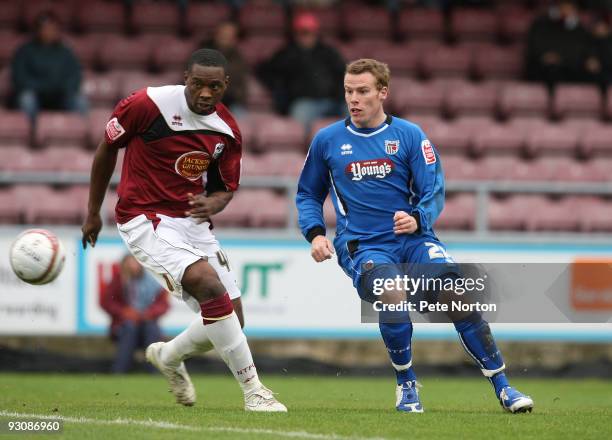 Patrick Kanyuka of Northampton Town and Danny North of Grimsby Town look for the ball during the Coca Cola League Two Match between Northampton Town...