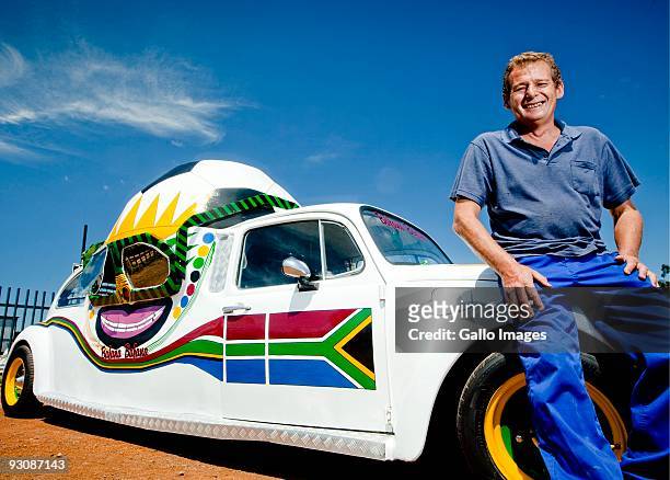 Wynand Viljoen poses next to his football-themed Volkswagen Beetle he created to show his support for Bafana Bafana on November 13, 2009 in Pretoria,...