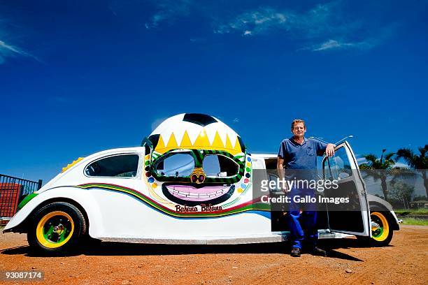 Wynand Viljoen poses next to his football-themed Volkswagen Beetle he created to show his support for Bafana Bafana on November 13, 2009 in Pretoria,...