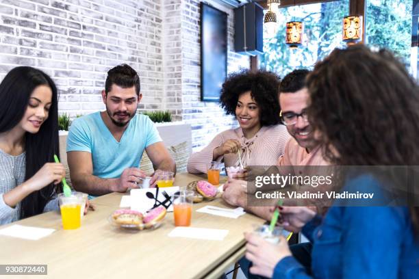 friends enjoying time together in ice cream cafe - tomando sorvete imagens e fotografias de stock