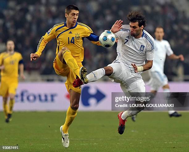 Greece's Georgios Samaras tackles Ukraine's Yevgen Khacheridi during their World Cup 2010 play-offs football match at the Olympic stadium in Athens...