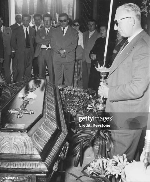 Italian race car driver and businessman Enzo Ferrari attends the funeral of Spanish racing driver Alfonso de Portago, 14th May 1957. De Portago was...