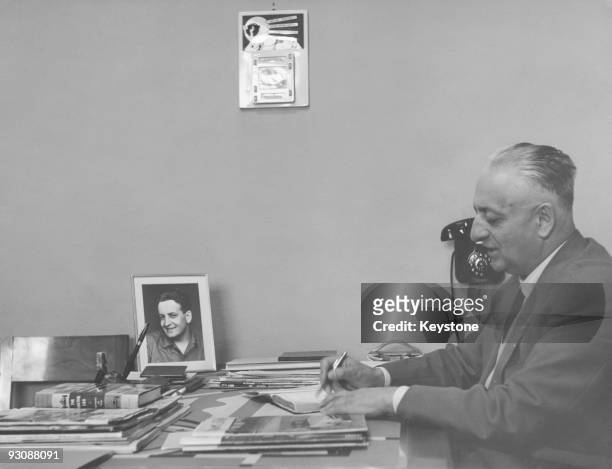 Italian race car driver and businessman Enzo Ferrari at work in his office, circa 1958. On his desk is a photograph of his son Alfredo, or Dino, who...