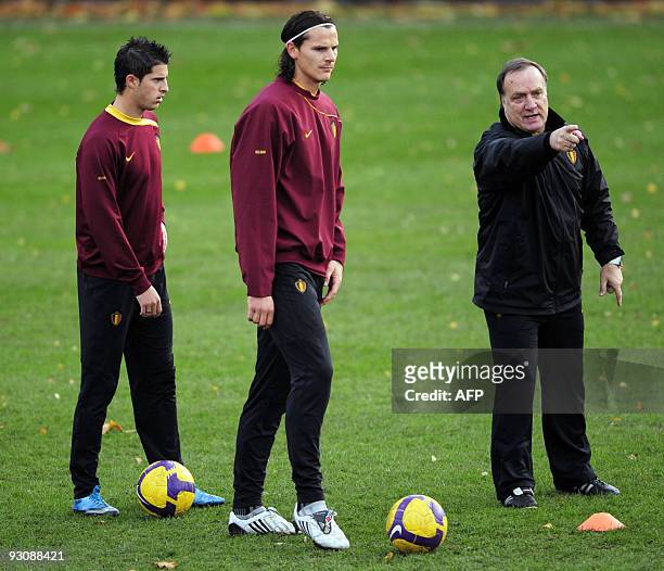 Red Devils coach Dick Advocaat talks to French striker Kevin Mirallas and defender Daniel Van Buyten during a training session on November 16, 2009...