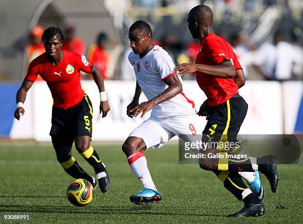 Ali Zitouni of Tunisia dribbles past Piato and Simao of Mozambique during the 2010 World Cup Qualifier match between Mozambique and Tunisia at the...