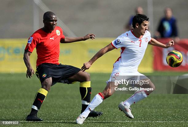 Hassen Nouiqui of Tunisia competes for the ball with Simao of Mozambique during the 2010 World Cup Qualifier match between Mozambique and Tunisia at...