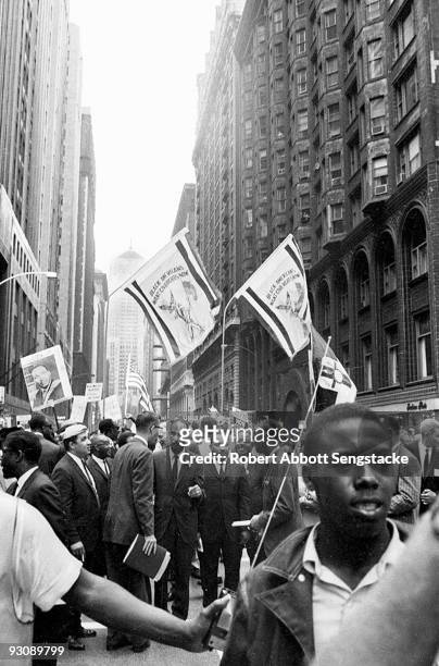 American Civil Rights leaders lead a protest march through the streets towards City Hall, Chicago, Illinois, July 10, 1966. Among those visible are...