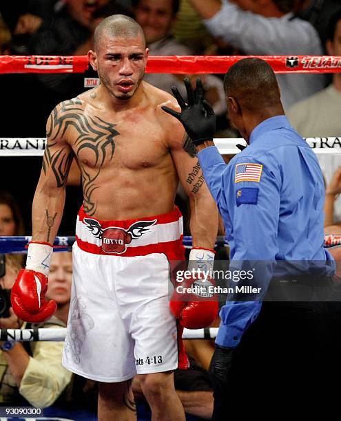 Referee Kenny Bayless counts after Miguel Cotto was knocked down in the fourth round by Manny Pacquiao during their WBO welterweight title fight at...