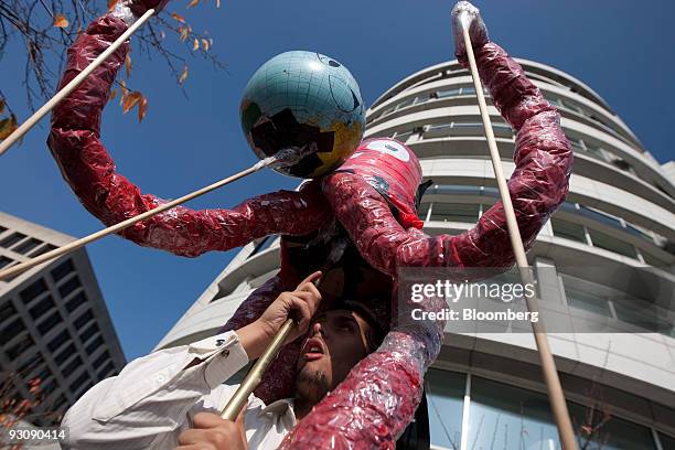 Miguel Rodeiguez holds up a vampire squid outside the offices of Goldman Sachs Group Inc. During a union rally in Washington, D.C., U.S., on Monday,...