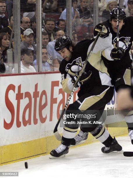 Eric Godard of the Pittsburgh Penguins handles the puck against the New Jersey Devils at Mellon Arena on November 12, 2009 in Pittsburgh,...