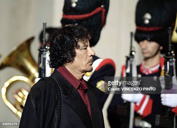 Libyan leader Moamer Kadhafi inspects an honour guard upon his arrival at Chigi Palace to meet Italian Prime Minister Silvio Berlusconi in Rome on...