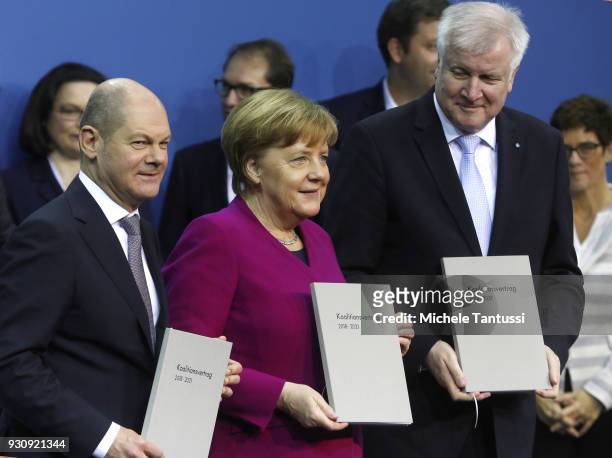 German Chancellor and Chairwoman of the German Christian Democrats Angela Merkel, Acting Chairman of the German Social Democrats Olaf Scholz, L, and...