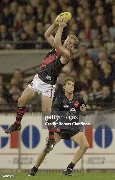 Mark Johnson for Essendon takes the mark as Matthew Lappin for Carlton looks on, in the match between the Carlton Blues and the Essendon Bombers,...