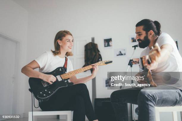 making music together - woman in guitar making studio stock pictures, royalty-free photos & images