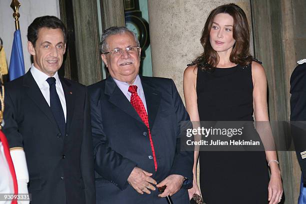 French president Nicolas Sarkozy, Iraq president Jalil Talabani and Carla Bruni-Sarkozy attend the dinner honoring Iraq President Jalil Talabani at...