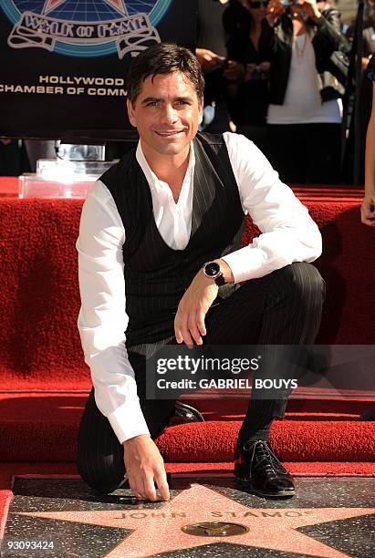 Actor John Stamos poses after being honored with a star on the Hollywood Walk of Fame in Hollywood, California on November 16, 2009. AFP PHOTO /...