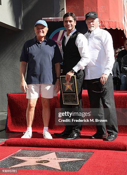 Actor John Stamos and The Beach Boys pose during induction ceremony on the Hollywood Walk of Fame on November 16, 2009 in Hollywood, California.