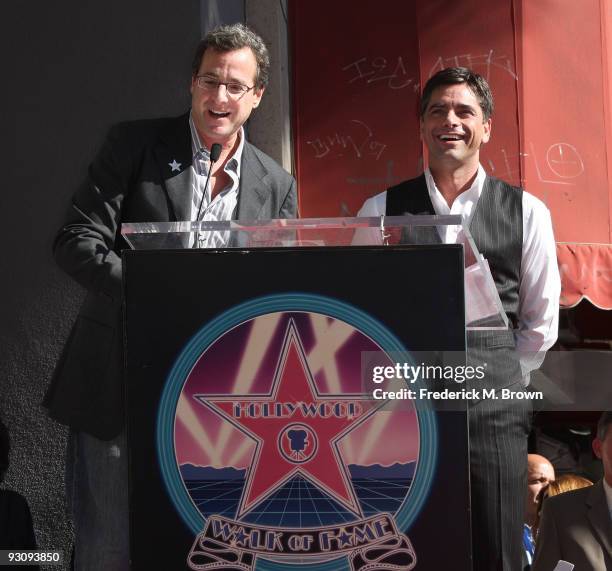 Comedian Bob Saget and actor John Stamos speak during the induction ceremony on the Hollywood Walk of Fame on November 16, 2009 in Hollywood,...