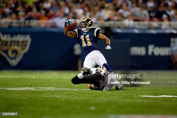 Brandon Gibson of the St. Louis Rams is tackled by Leigh Torrence of the New Orleans Saints at the Edward Jones Dome on November 15, 2009 in St....