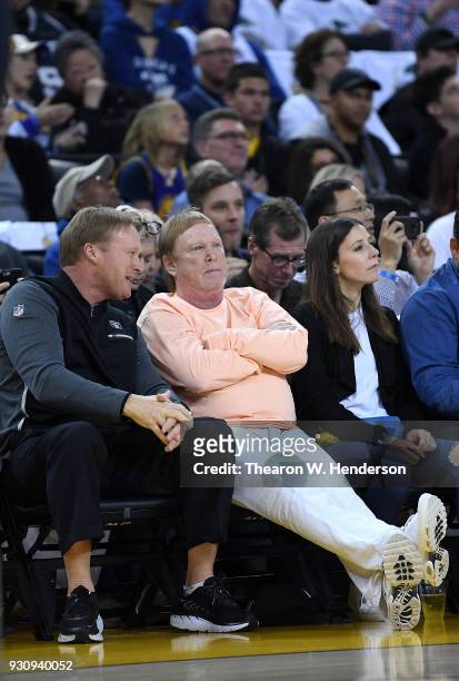 Oakland Raiders head coach John Gruden and Raiders owner Mark Davis at courtside watching an NBA basketball game between the San Antonio Spurs and...